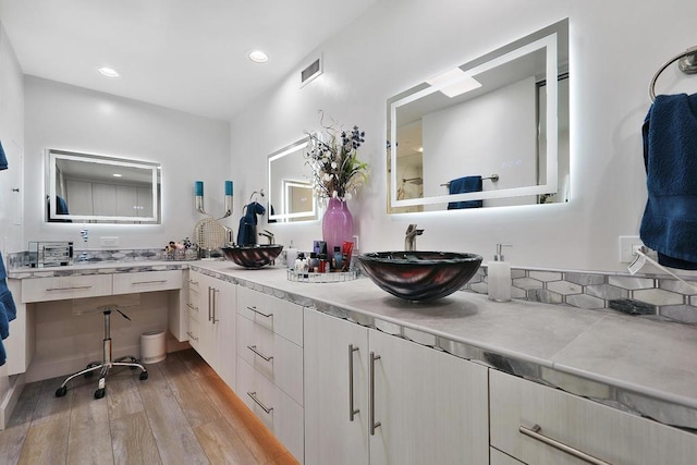 bathroom with hardwood / wood-style floors and vanity