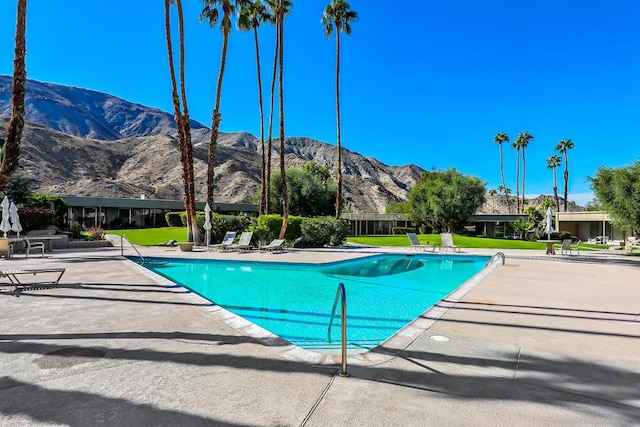 view of pool with a mountain view and a patio