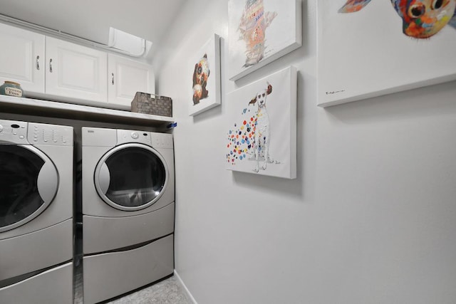 washroom with washing machine and dryer and cabinets