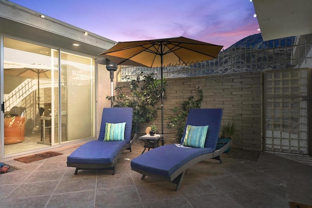 view of patio terrace at dusk