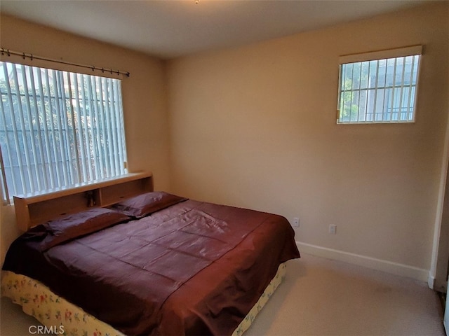 bedroom featuring carpet and multiple windows