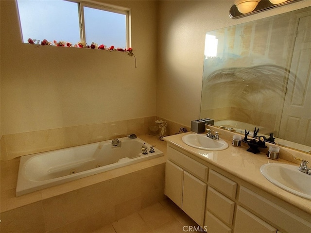 bathroom with tile patterned floors, tiled tub, and vanity