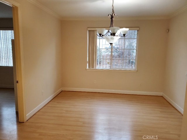 unfurnished dining area featuring a notable chandelier, ornamental molding, and light hardwood / wood-style flooring