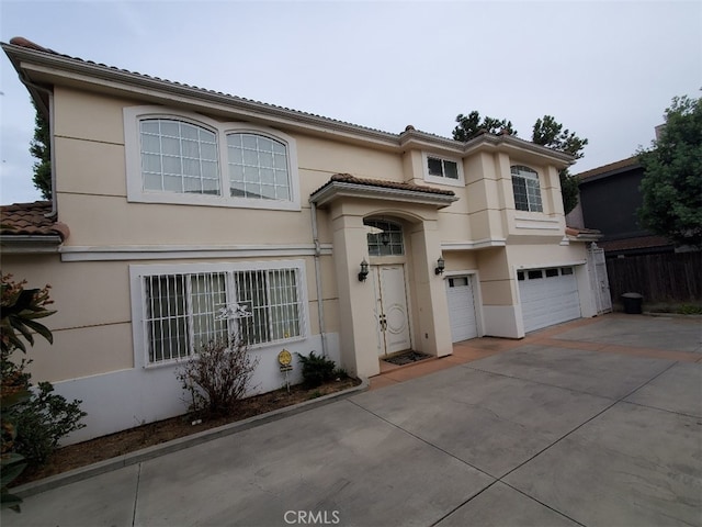 mediterranean / spanish-style house with a garage