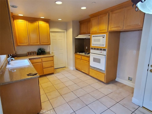 kitchen featuring sink, white appliances, and light tile patterned floors