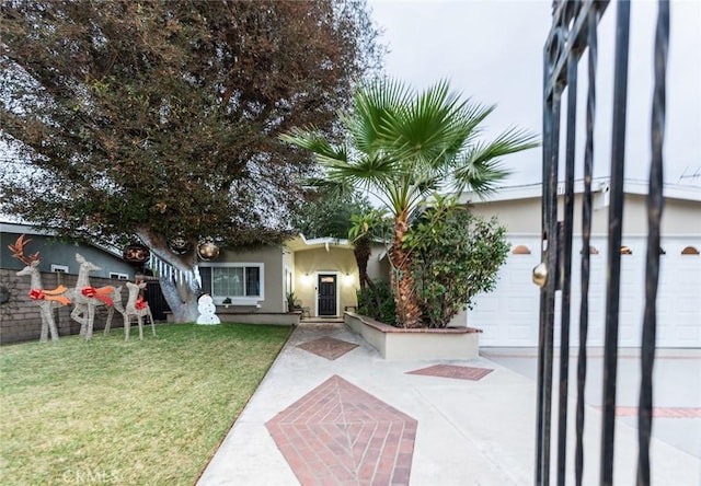 ranch-style home featuring a garage and a front yard