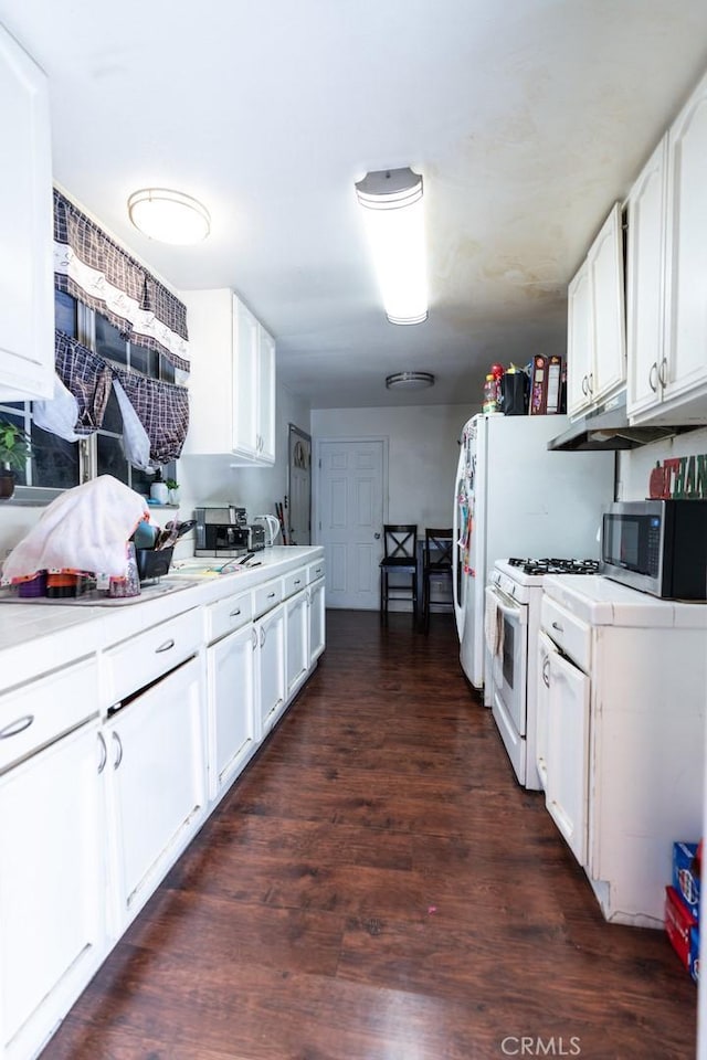 kitchen featuring white cabinetry, dark hardwood / wood-style flooring, and white gas stove