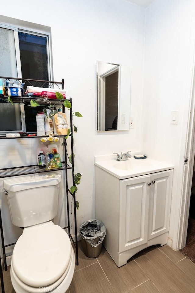 bathroom featuring toilet and vanity