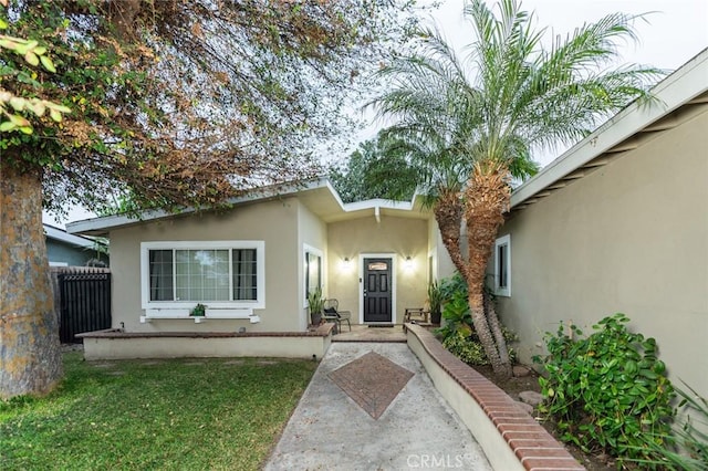 entrance to property with a lawn