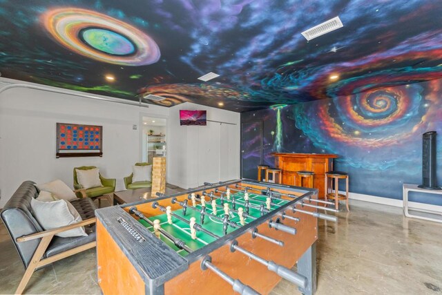 game room with indoor bar