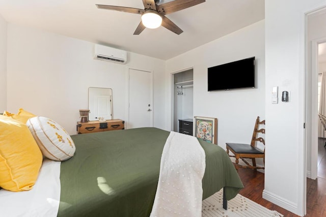 bedroom featuring a wall unit AC, ceiling fan, a closet, and dark wood-type flooring