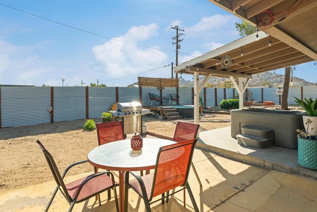 view of patio featuring a water view and a grill