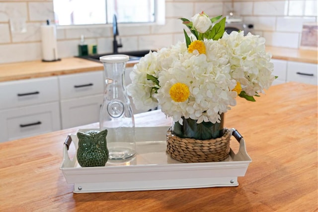 interior details featuring white cabinets and sink