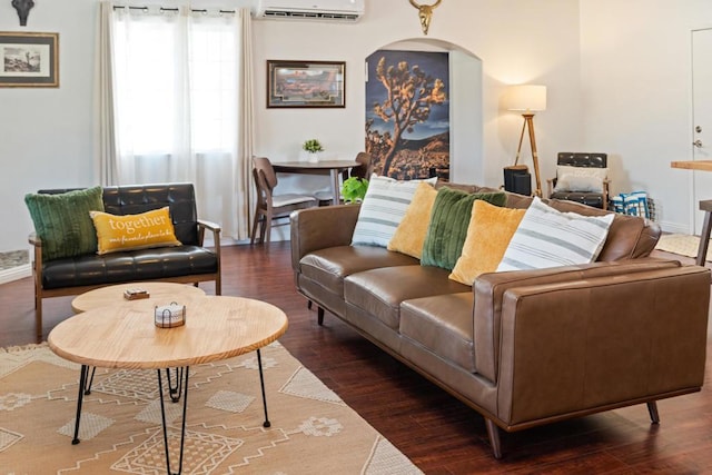 living room with an AC wall unit and dark hardwood / wood-style flooring