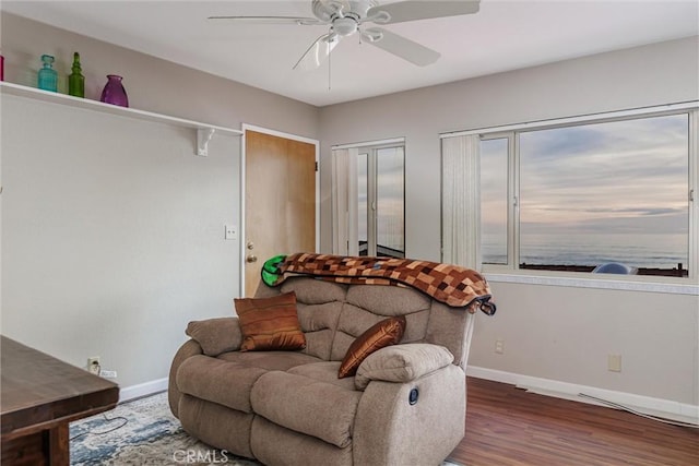 living area with ceiling fan and hardwood / wood-style floors