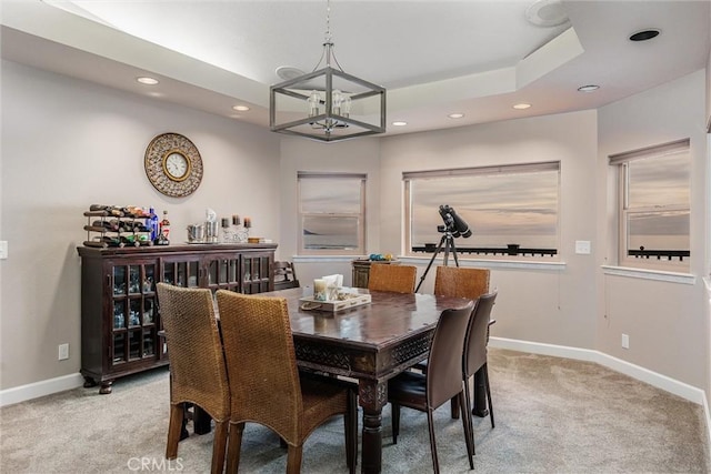 dining area featuring an inviting chandelier and light colored carpet