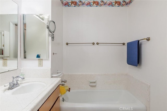 bathroom featuring a tub to relax in and vanity