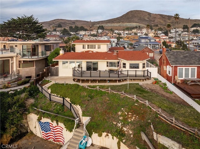 back of house with a deck with mountain view