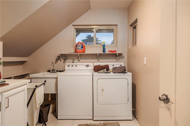 laundry area featuring washer and dryer and light tile patterned flooring