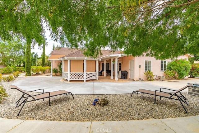 rear view of house featuring a patio