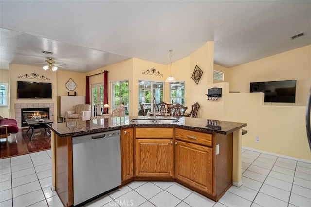 kitchen with stainless steel dishwasher, sink, and light tile patterned flooring