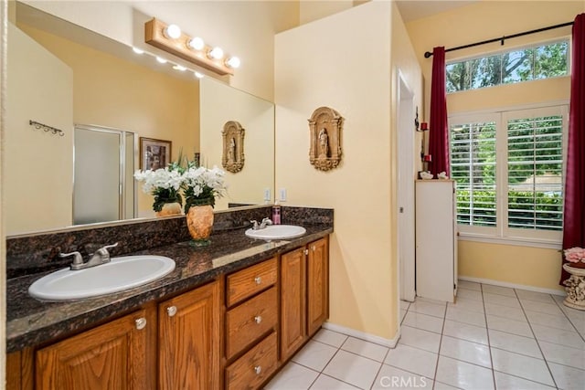 bathroom featuring a shower with shower door, tile patterned floors, and vanity