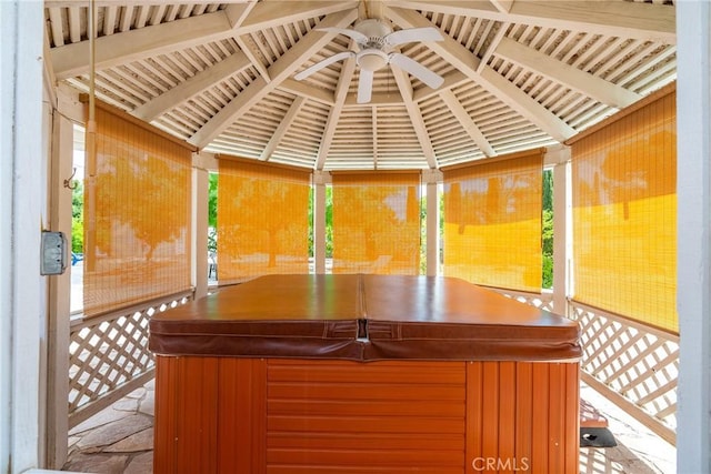 exterior space with ceiling fan, a gazebo, and a hot tub