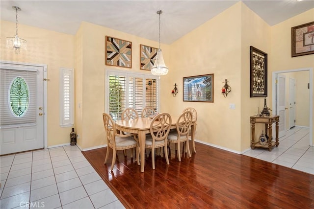 tiled dining room with a notable chandelier