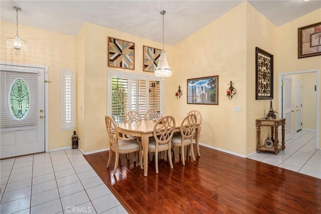 dining area with light tile patterned floors and a chandelier