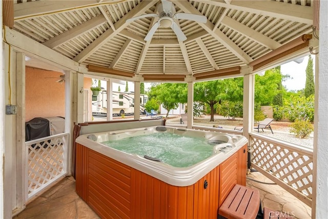 sunroom featuring ceiling fan and a jacuzzi