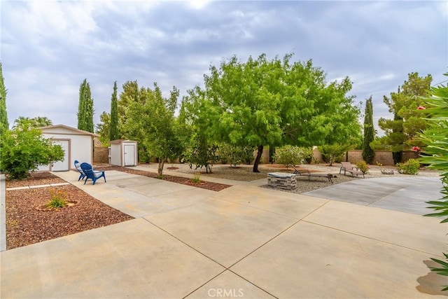 view of patio / terrace featuring a shed and an outdoor fire pit