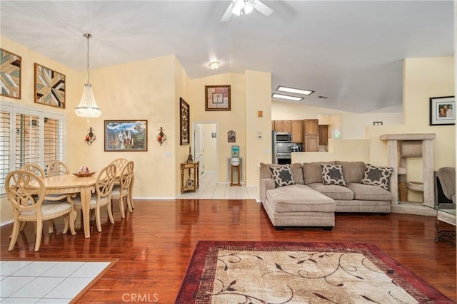 living room with lofted ceiling, ceiling fan, and hardwood / wood-style floors