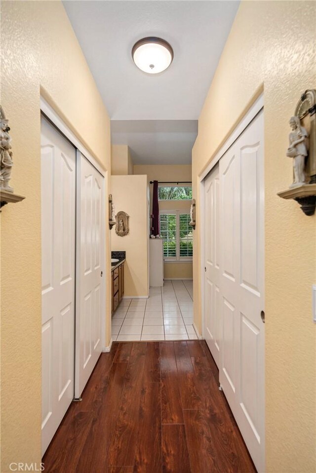 corridor with hardwood / wood-style floors