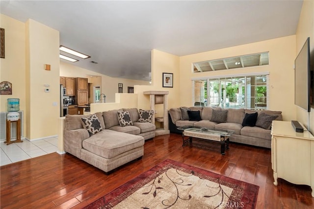 living room with vaulted ceiling and light hardwood / wood-style flooring