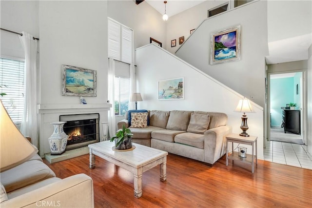 living room featuring a high ceiling and hardwood / wood-style floors