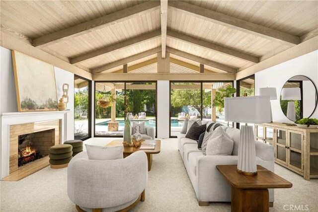 living room featuring vaulted ceiling with beams, light colored carpet, and a high end fireplace