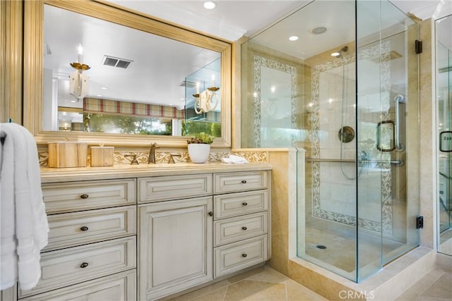 bathroom with tile patterned flooring, vanity, and a shower with shower door