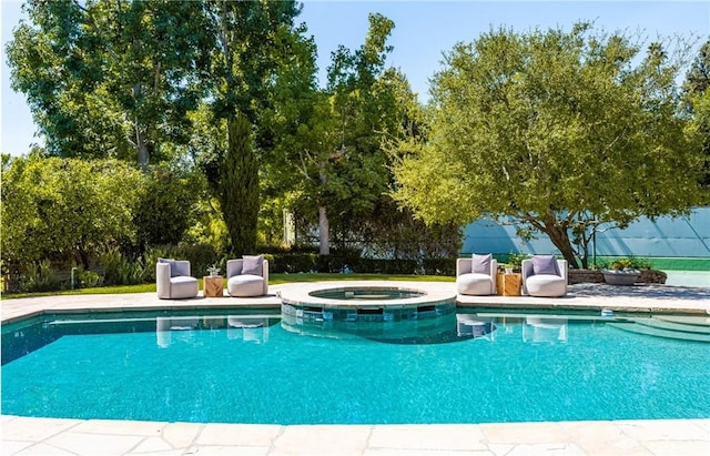 view of swimming pool featuring an in ground hot tub