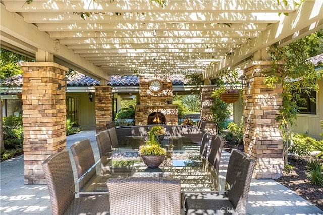 view of patio featuring a pergola and an outdoor stone fireplace