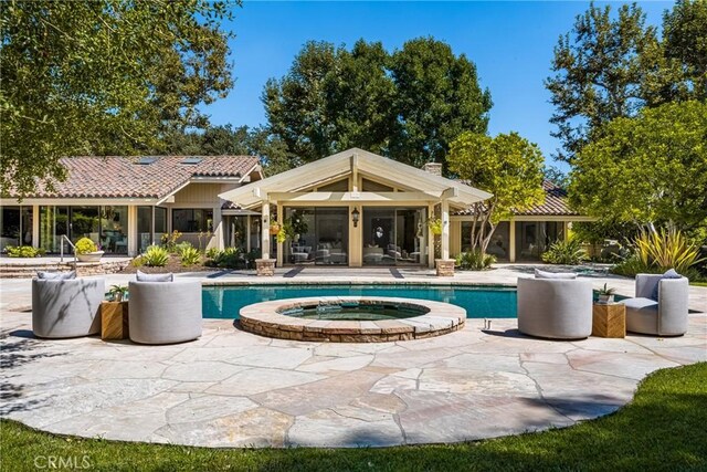 view of swimming pool with an in ground hot tub and a patio area