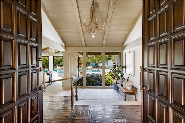 sunroom with vaulted ceiling with beams, a notable chandelier, and wooden ceiling