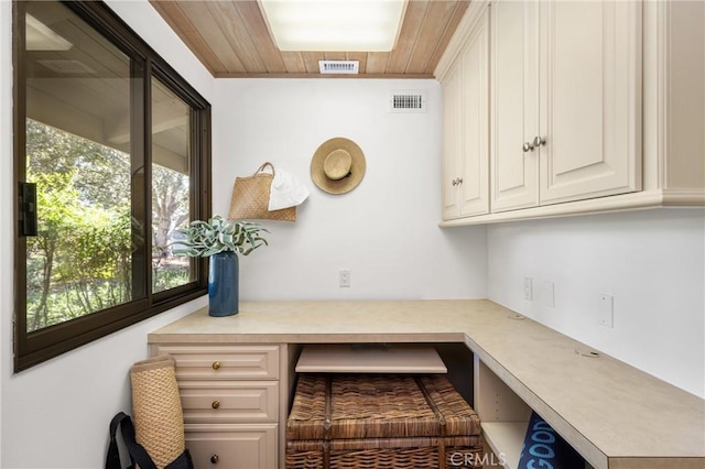 home office featuring wood ceiling and built in desk