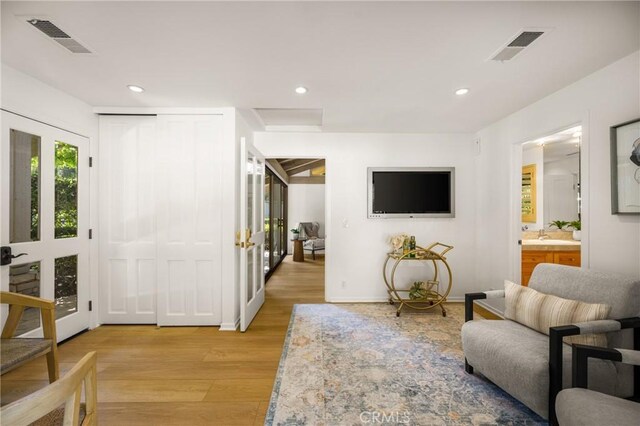 living room with sink and light hardwood / wood-style floors