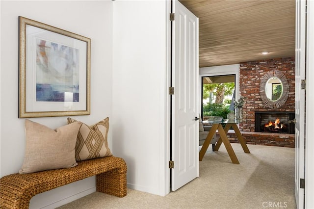 interior space with light carpet, a fireplace, and wooden ceiling