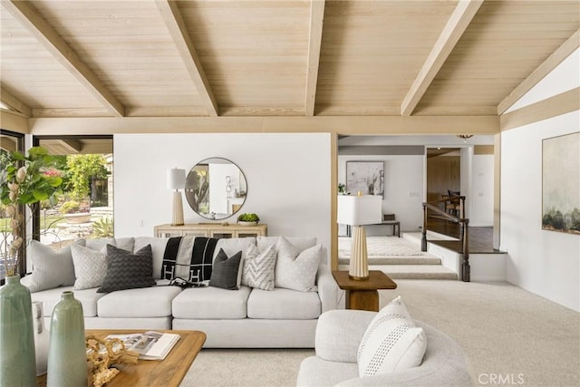 living room with vaulted ceiling with beams and carpet flooring