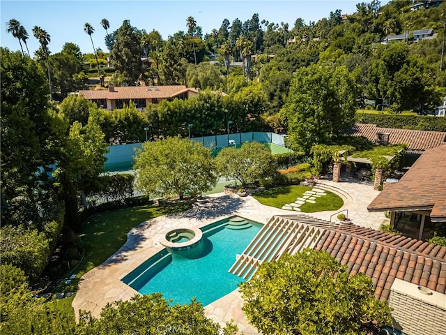 view of swimming pool featuring an in ground hot tub and a patio area