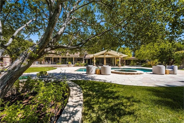 view of swimming pool with a patio area and an in ground hot tub