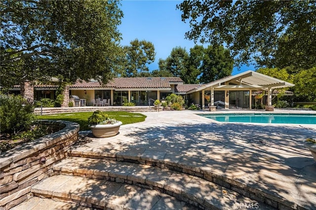 view of swimming pool with a pergola and a patio