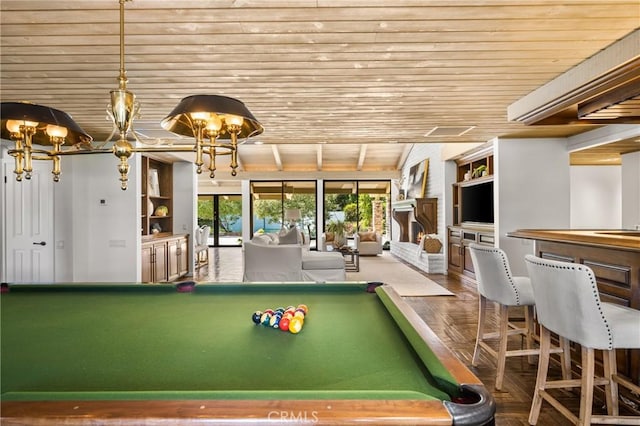 game room with wood ceiling, a fireplace, and pool table