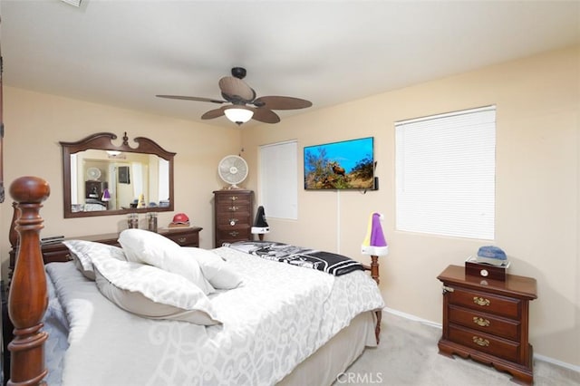 bedroom featuring ceiling fan and light carpet